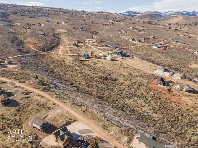 Aerial overview of property's location with a mountainous background and rural landscape