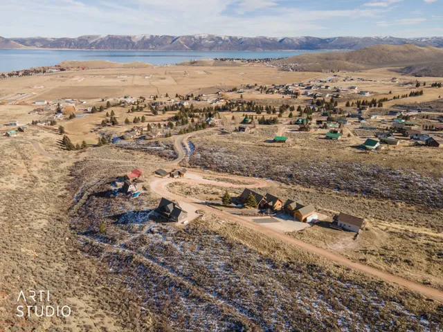Aerial view of property and surrounding area with a water and mountain view