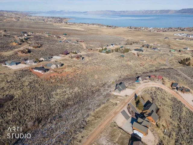 Aerial view of property and surrounding area with nearby suburban area and a water and mountain view