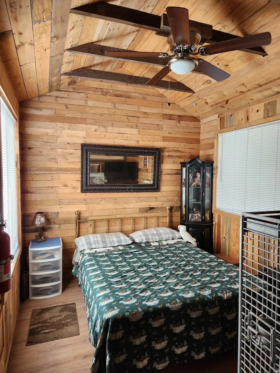 Bedroom with wood paneling, ceiling fan