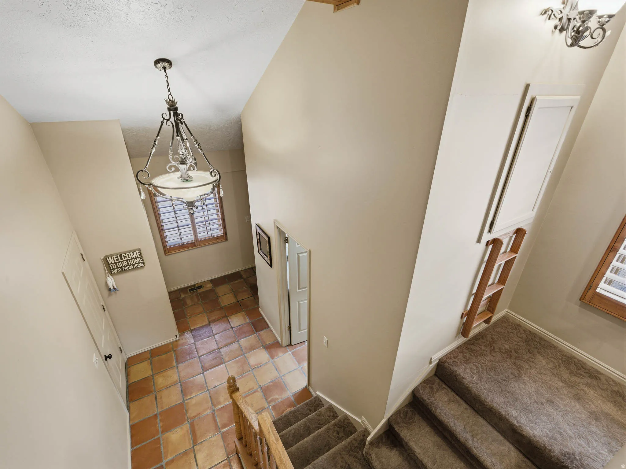 Stairs featuring a high ceiling and carpet