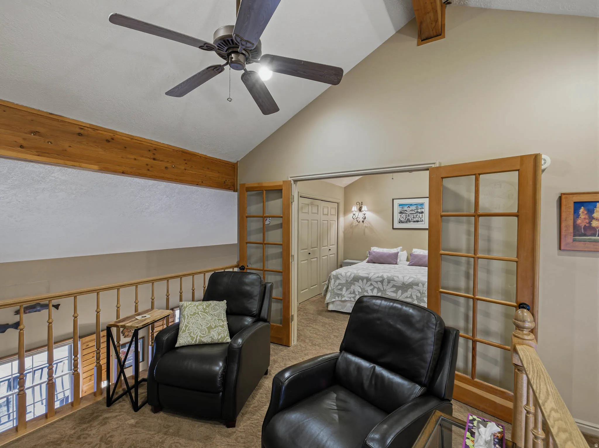 Sitting room with carpet floors, a ceiling fan, and beam ceiling