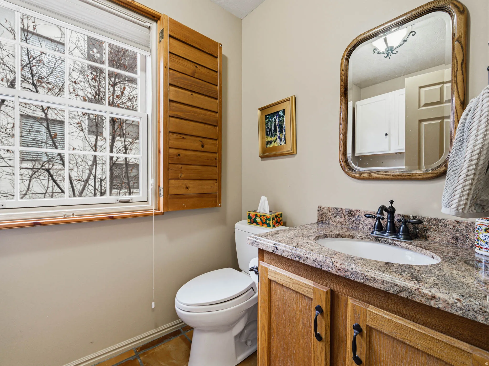 Half bathroom featuring vanity and toilet