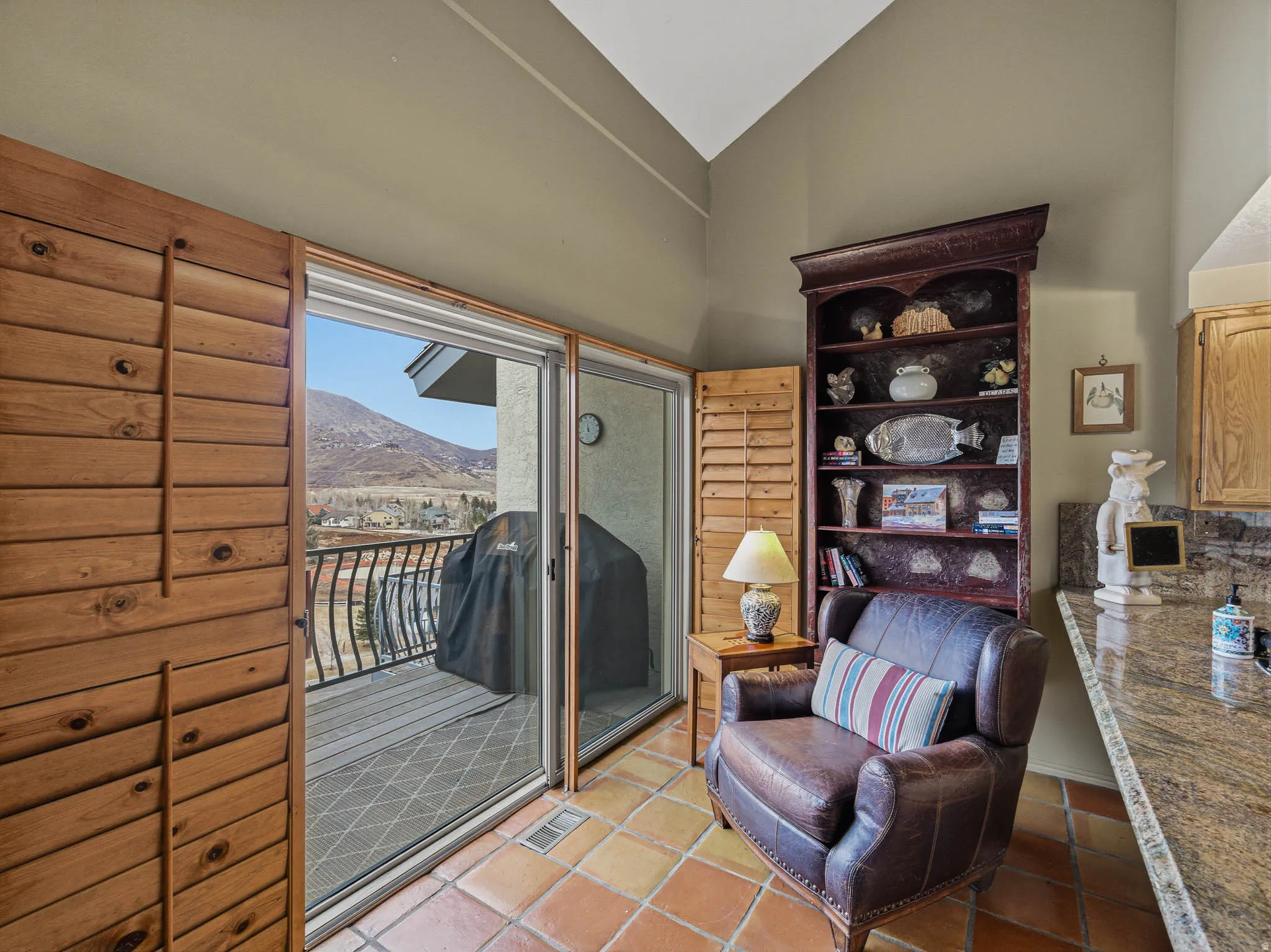 Sitting room with a mountain view and lofted ceiling