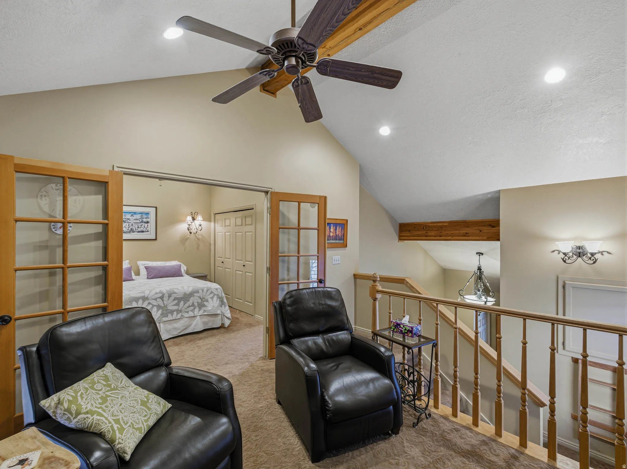 Carpeted bedroom featuring ceiling fan, a closet, beamed ceiling, and hanging lights