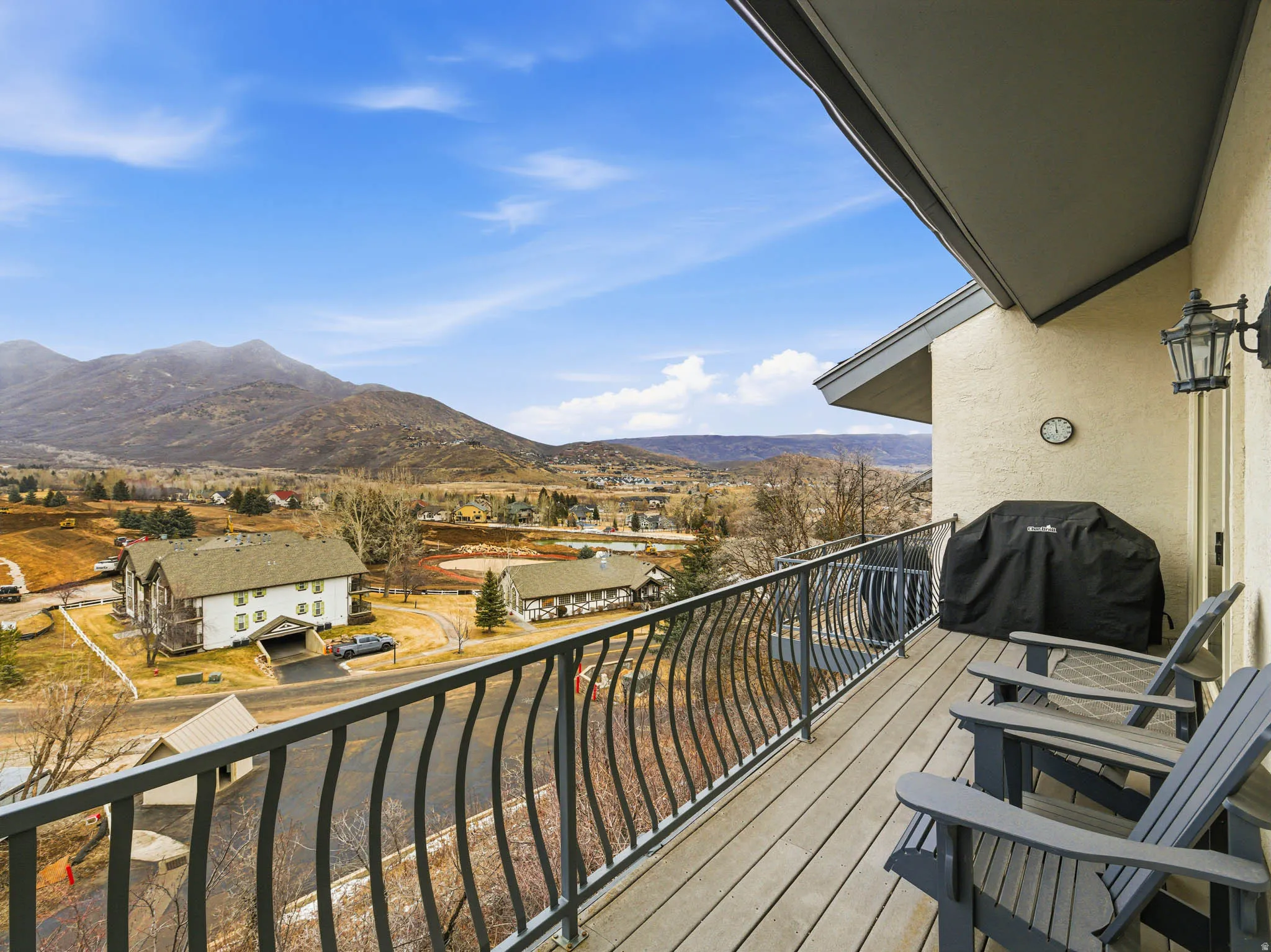 Balcony with area for grilling, a mountain view, and a residential view