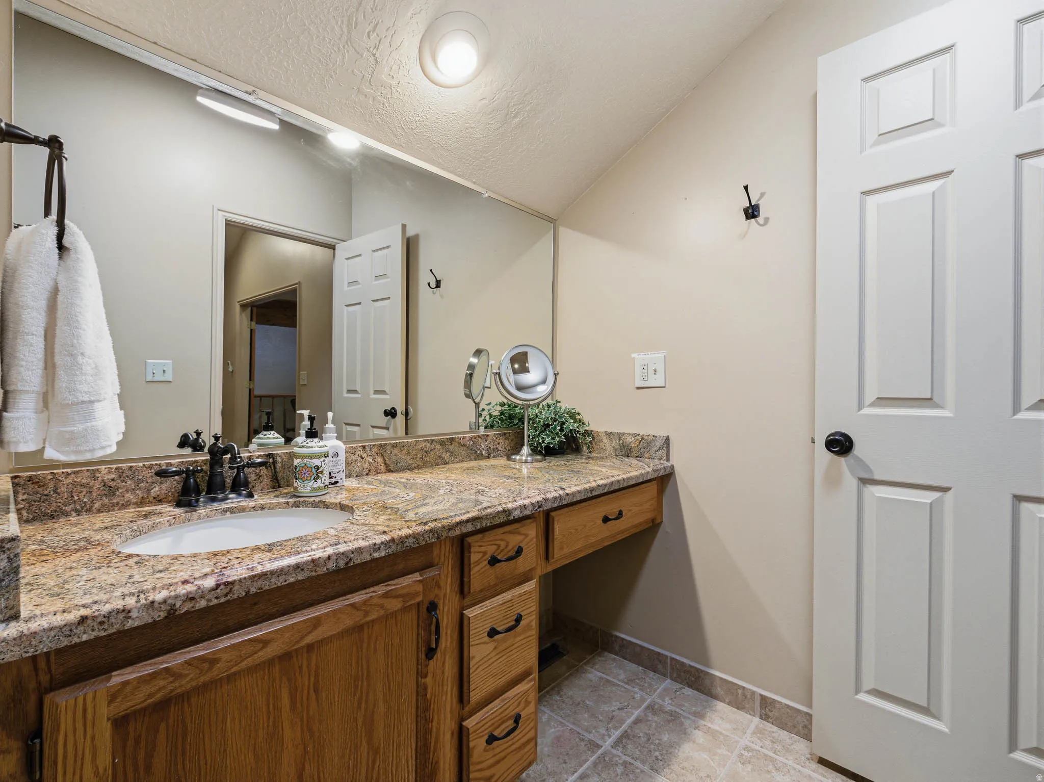 Bathroom with vanity and a textured ceiling