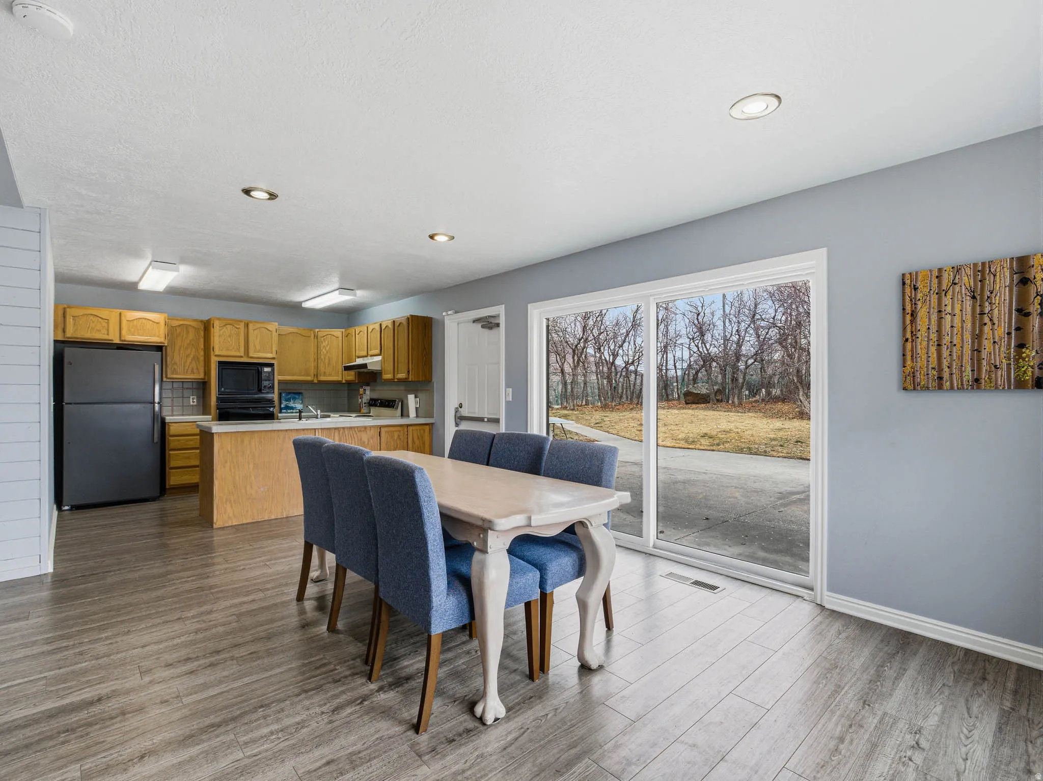 Dining space with dark wood-type flooring and recessed lighting