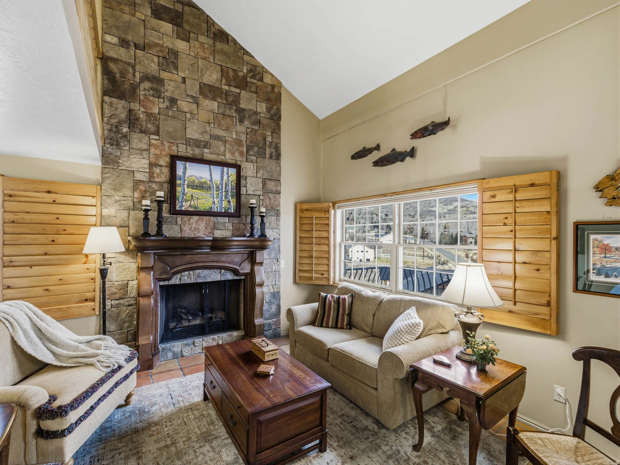 Living room featuring lofted ceiling and a fireplace