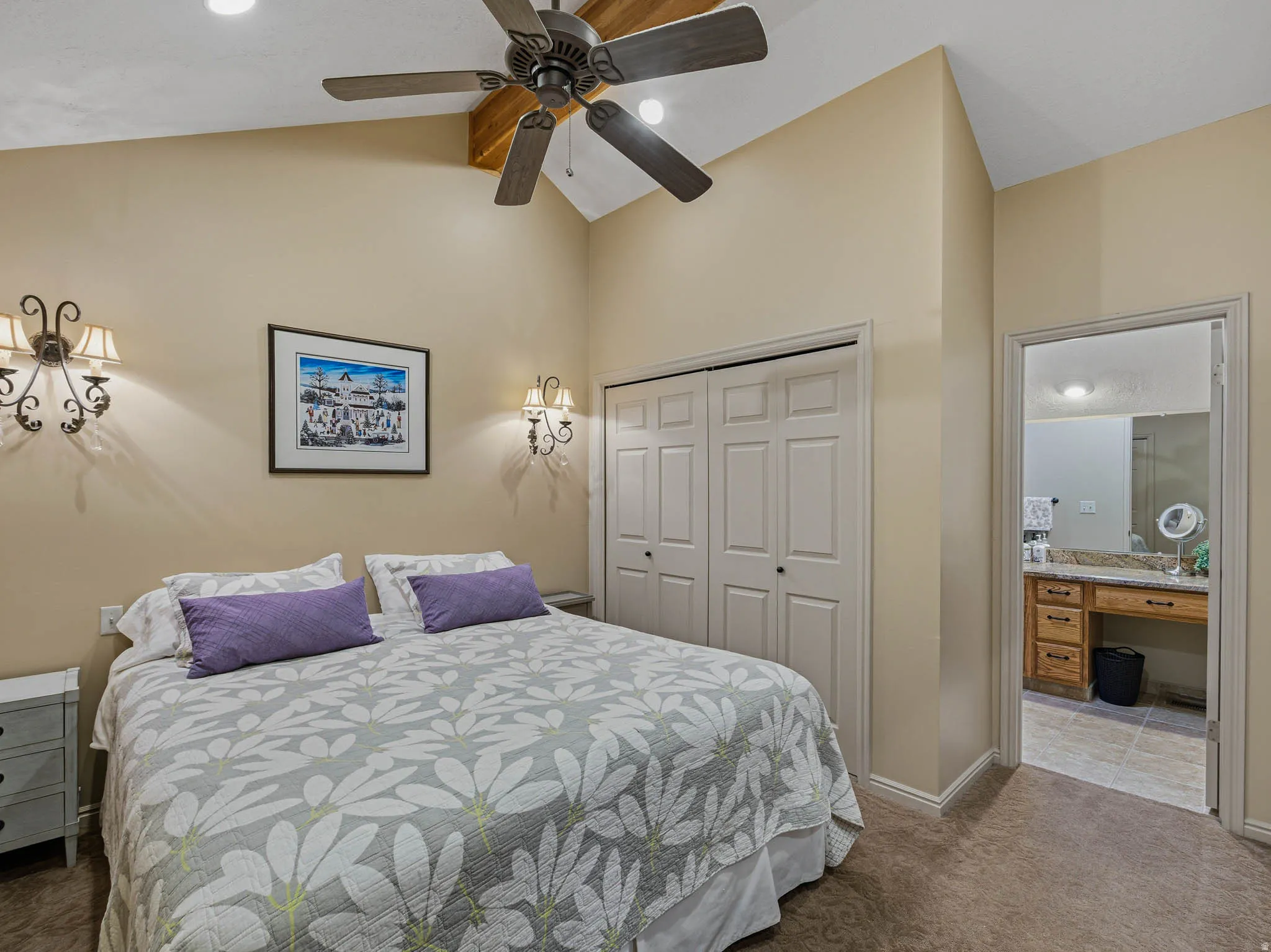 Bedroom with vaulted ceiling, a closet, carpet, ceiling fan, and an office area