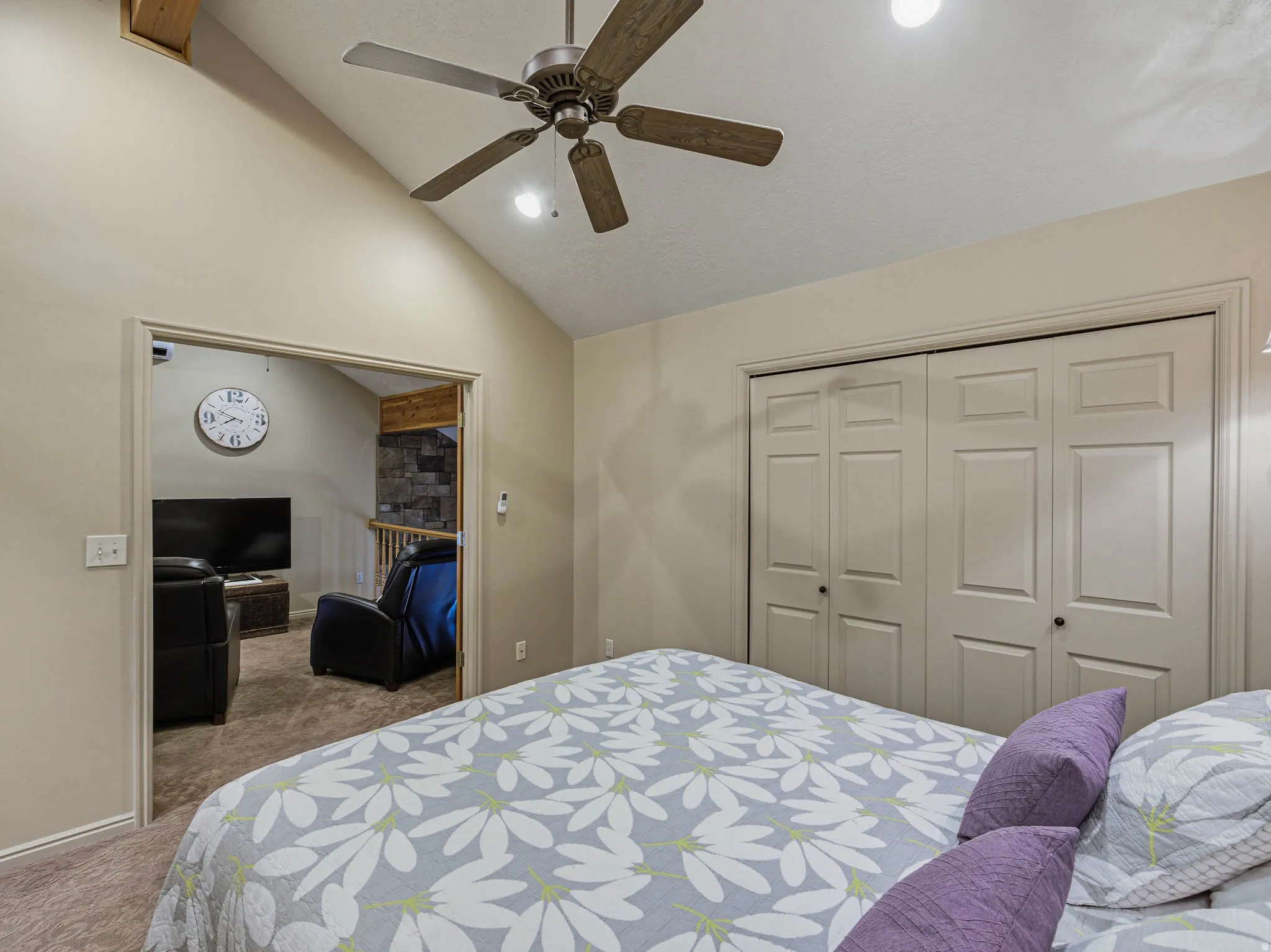 Carpeted bedroom with vaulted ceiling, ceiling fan, a closet, and recessed lighting