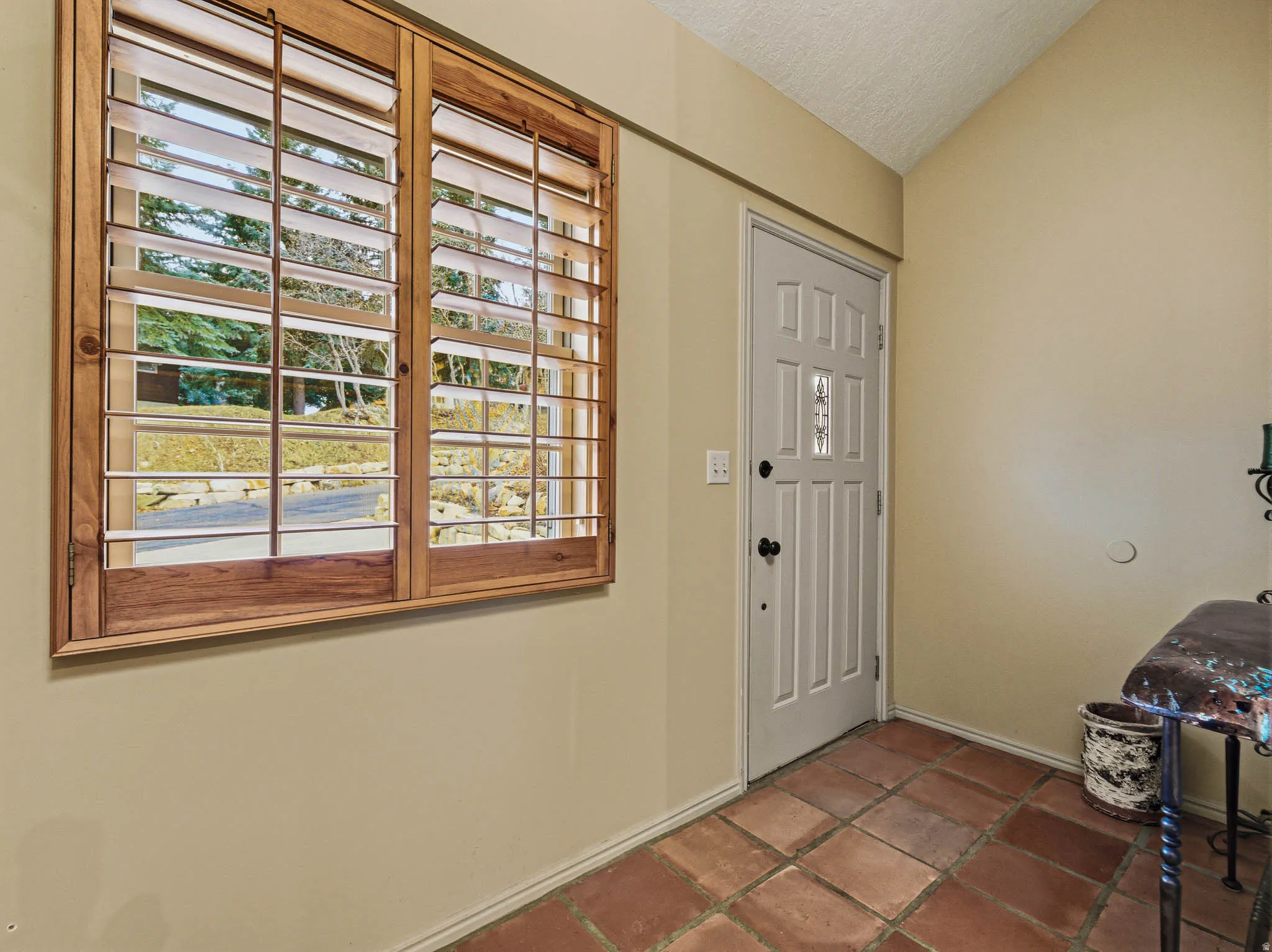 Foyer entrance with baseboards and lofted ceiling