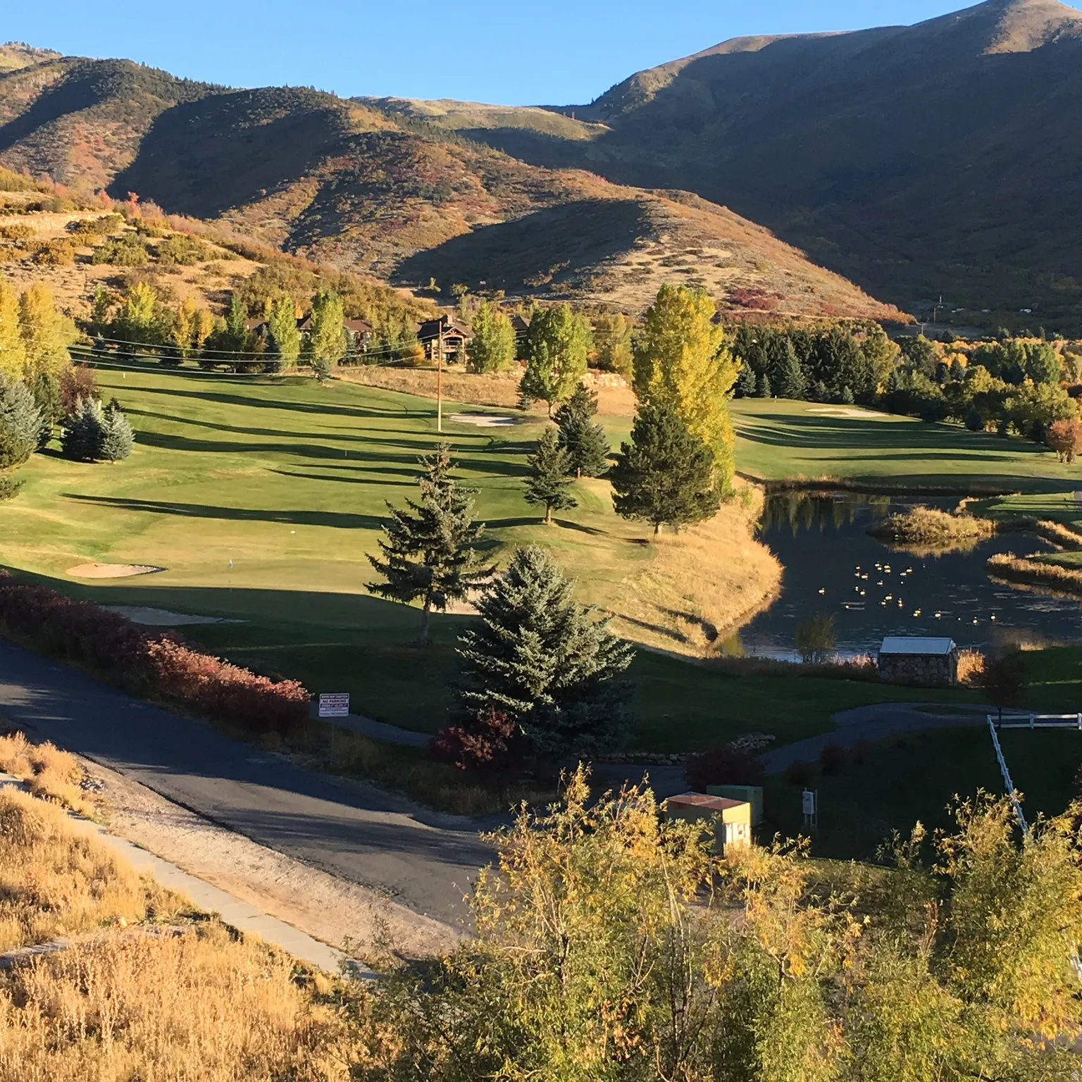 View of community with a water and mountain view and golf course view
