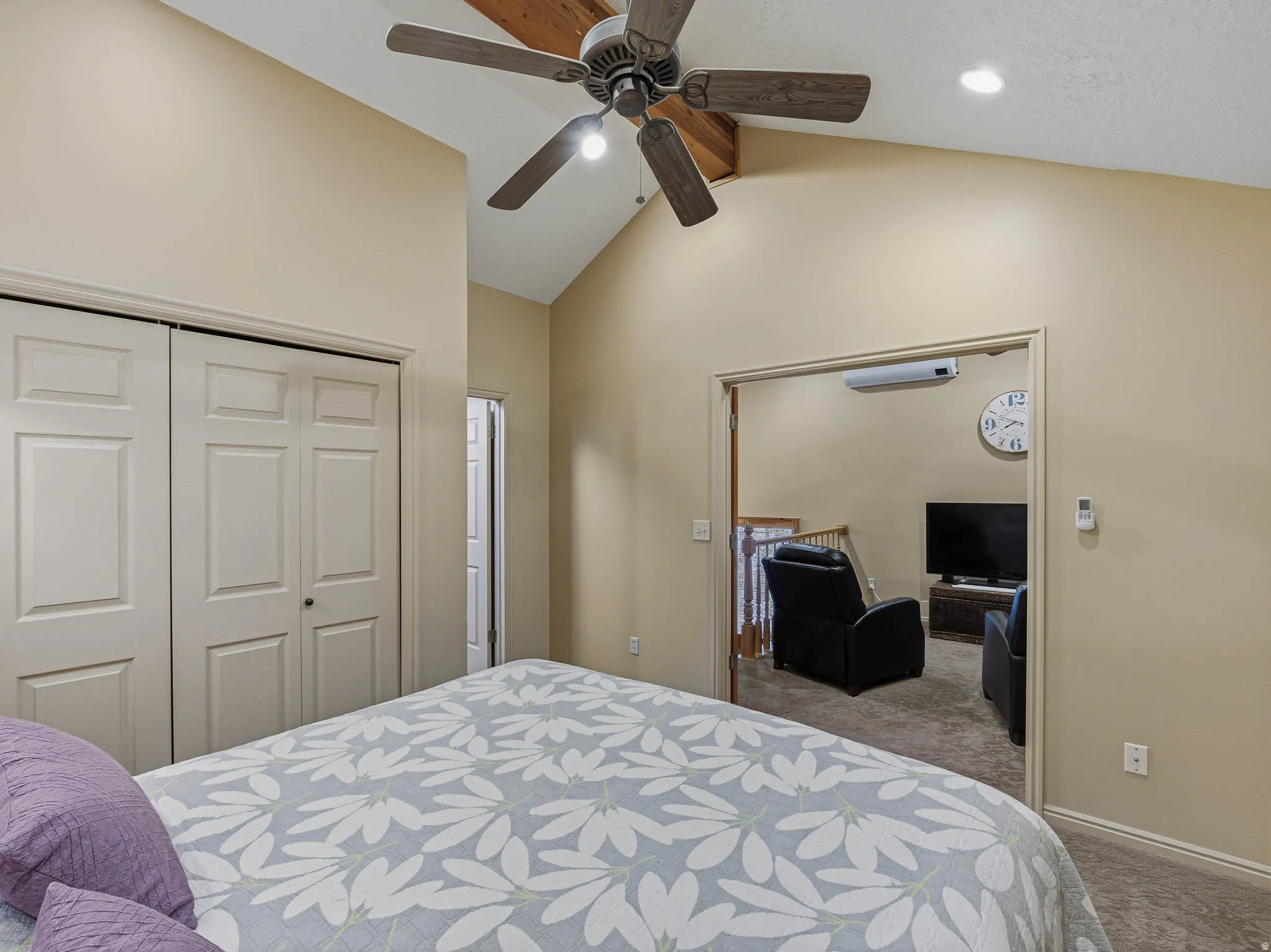 Bedroom with vaulted ceiling, carpet floors, a closet, recessed lighting, and a ceiling fan