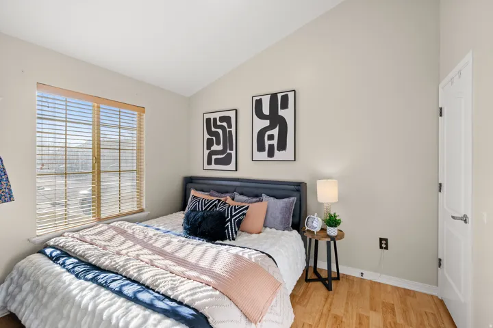 Bedroom featuring vaulted ceiling and wood finished floors