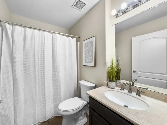 Full bathroom featuring vanity and a shower with shower curtain