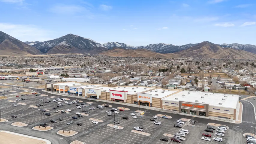 Drone / aerial view of a commercial area and a mountain backdrop