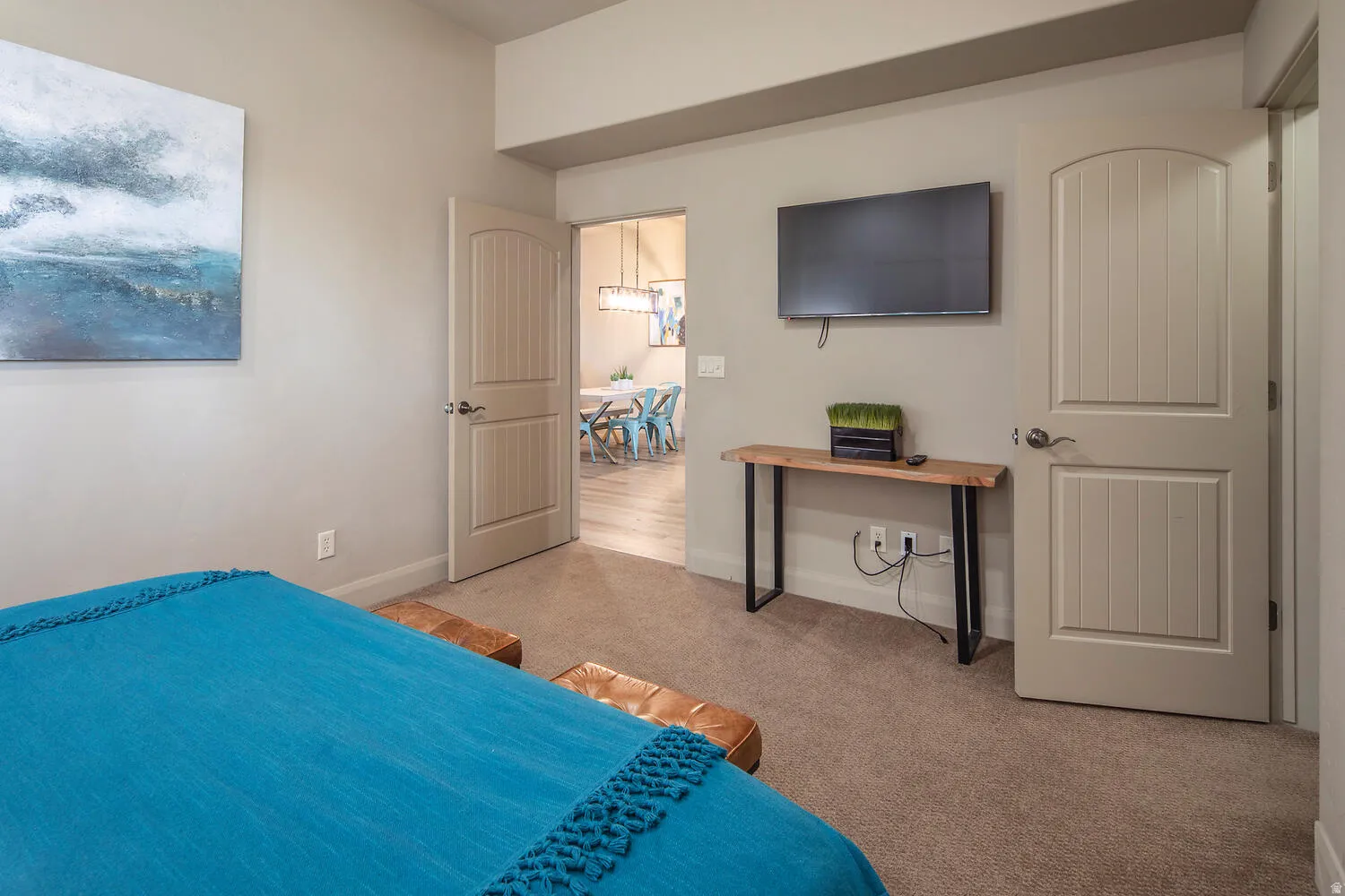 Bedroom featuring light colored carpet and baseboards