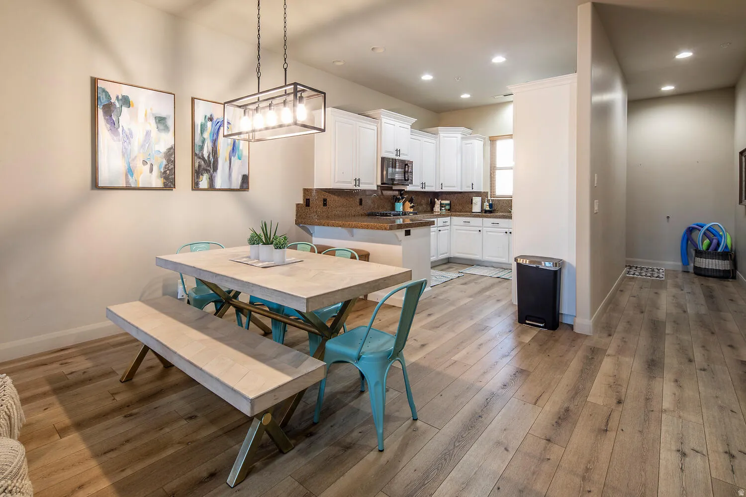 Dining space with light wood finished floors and recessed lighting