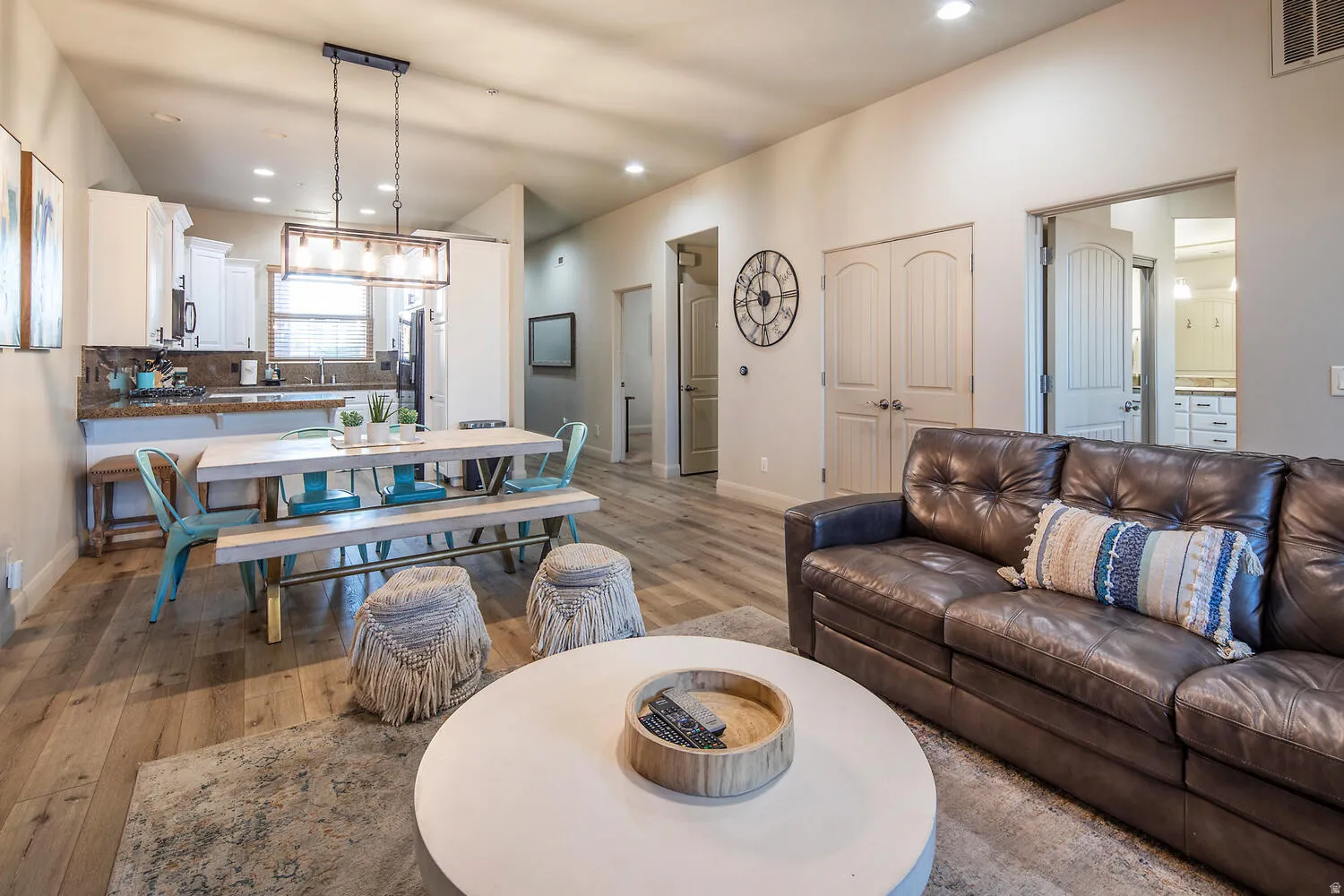 Living area with light wood-style floors and recessed lighting