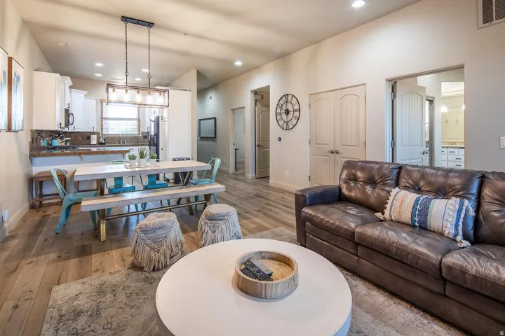 Living area with light wood-style floors and recessed lighting