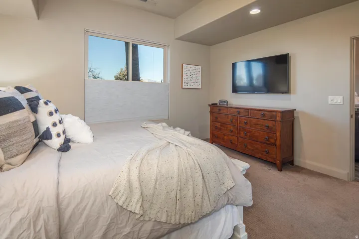 Carpeted bedroom with baseboards and recessed lighting
