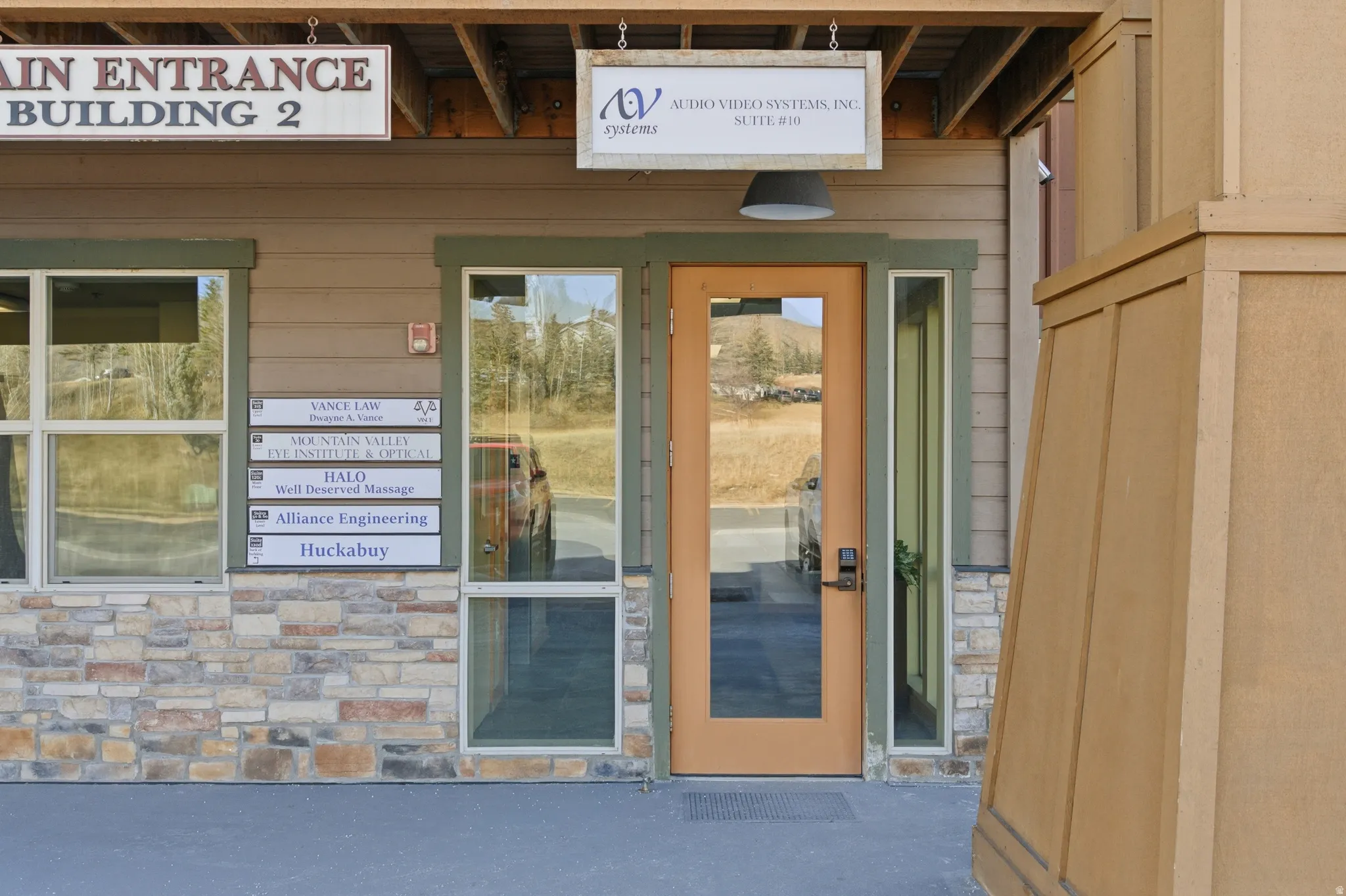 Doorway to property featuring stone siding