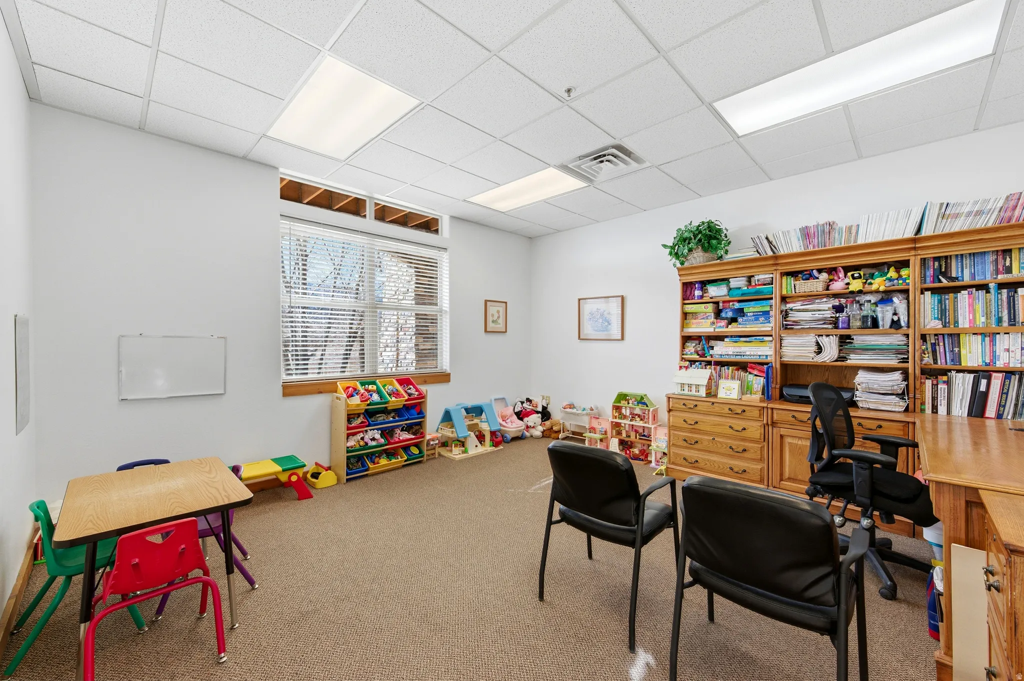 Playroom with a paneled ceiling and an office area