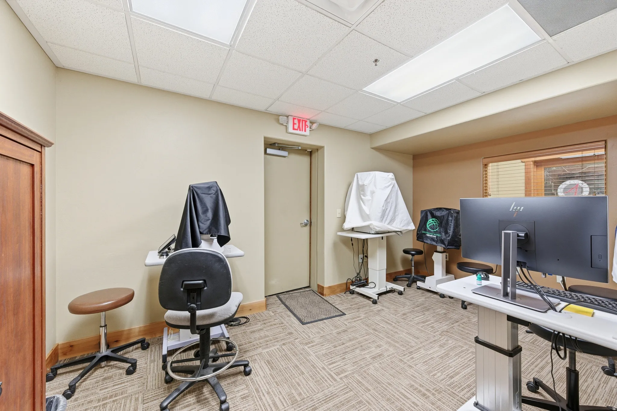 Misc room featuring a paneled ceiling and a desk