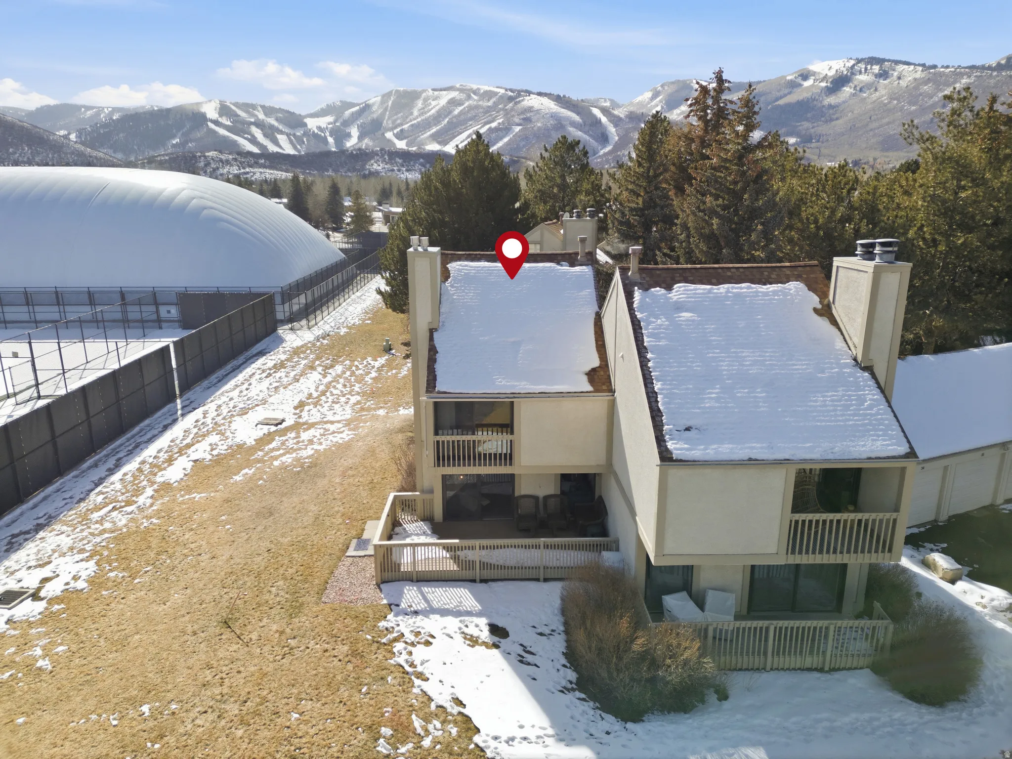 Snowy aerial view featuring a mountain view
