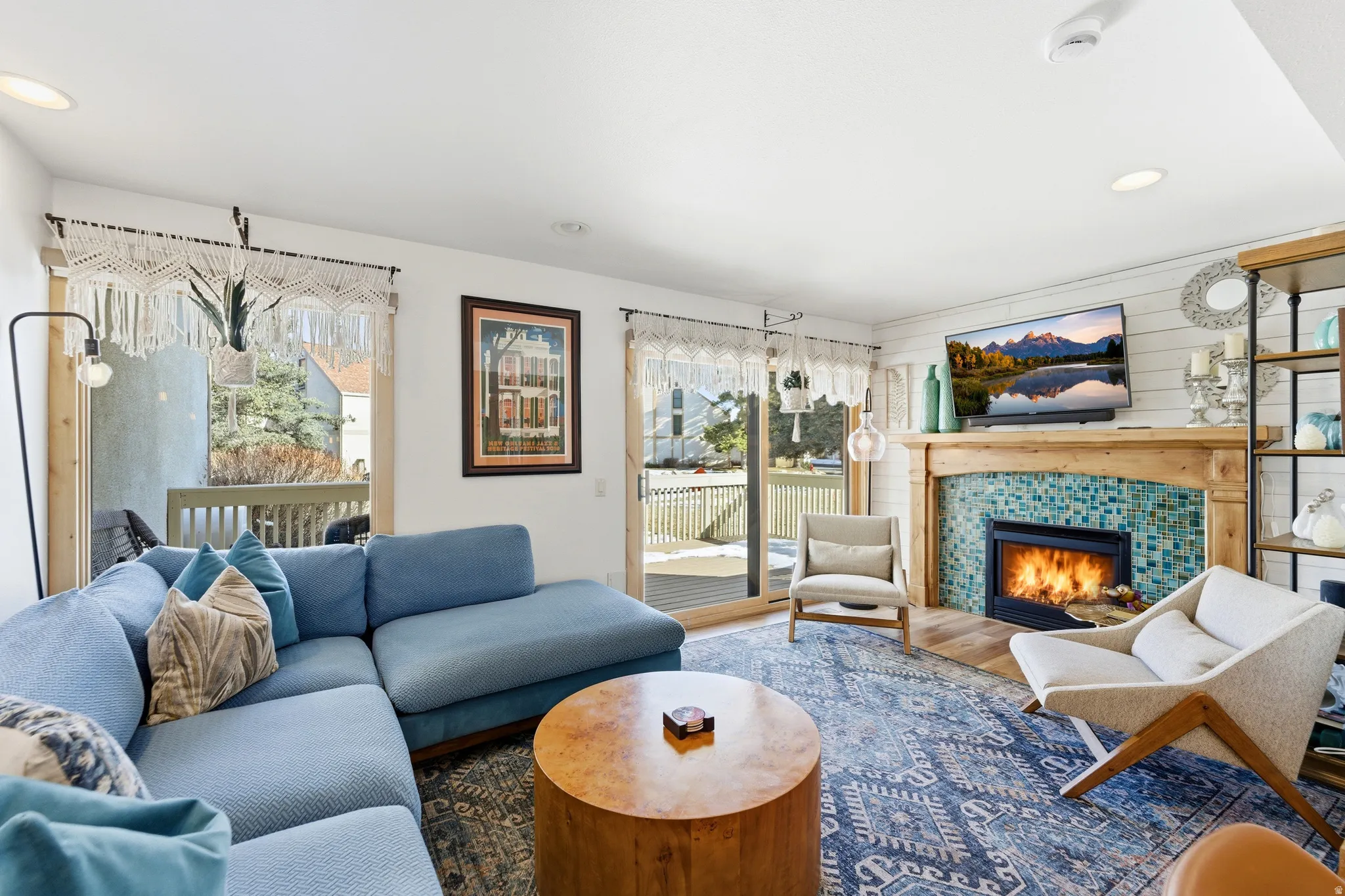 Living room with recessed lighting, a tile fireplace, plenty of natural light, and wood finished floors