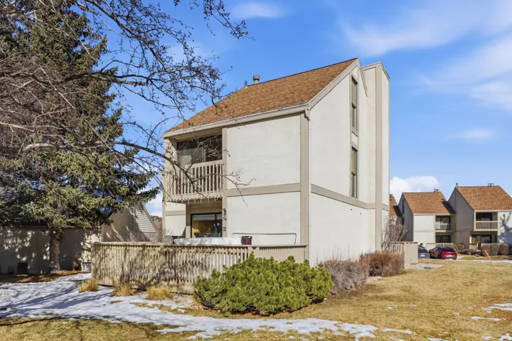 Rear view of property with a balcony and stucco siding