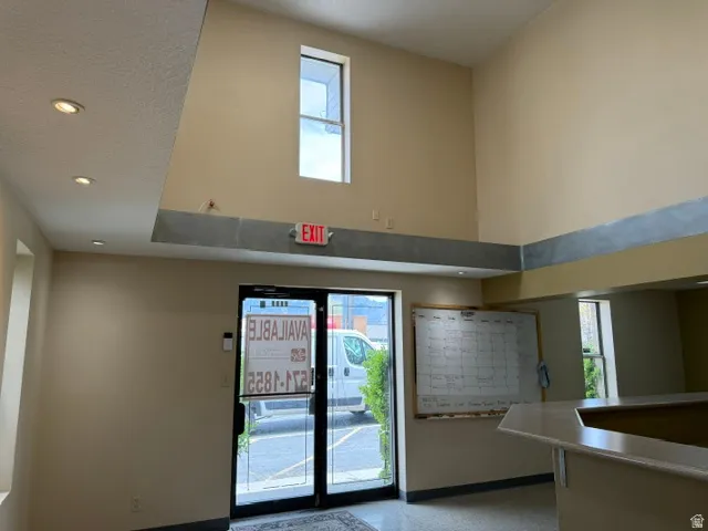 Doorway to outside featuring a high ceiling and recessed lighting