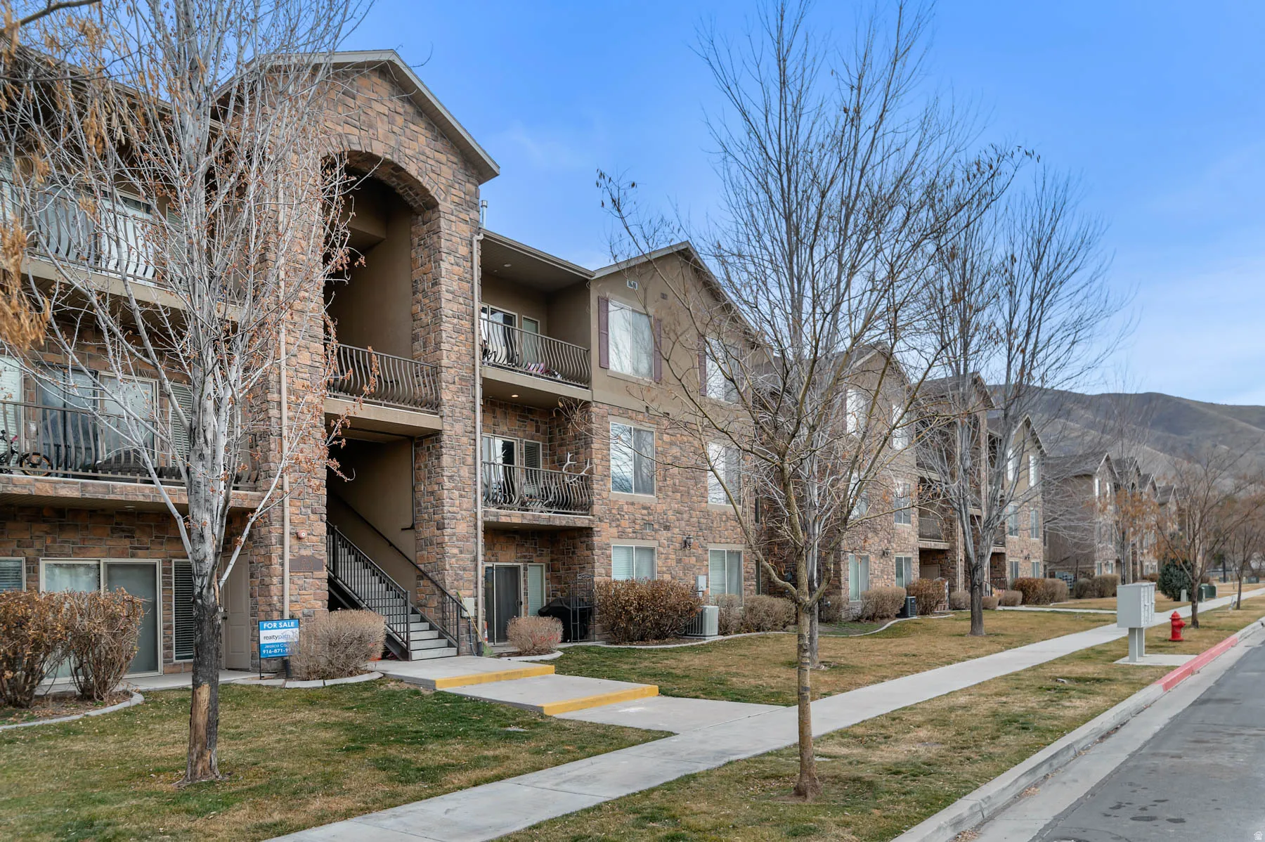 View of apartment building / complex with stairs