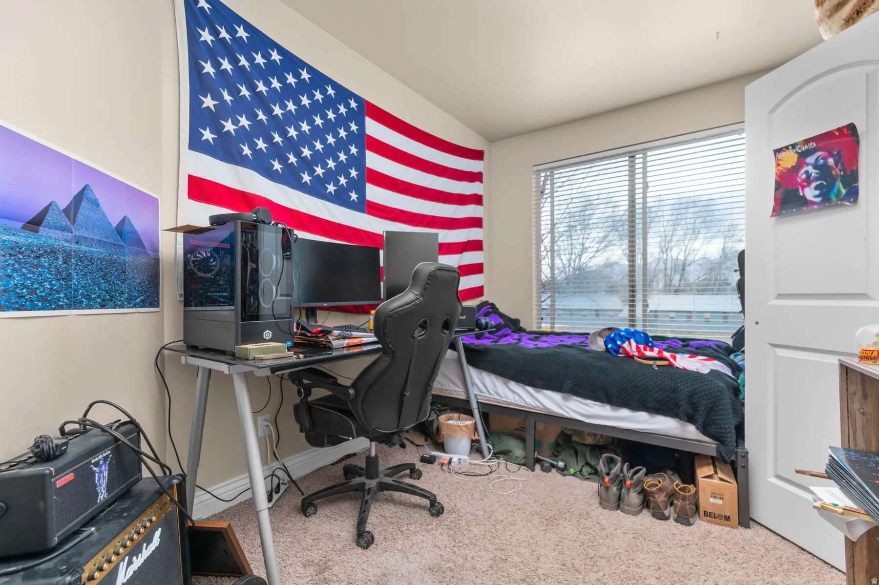 Carpeted bedroom with a desk