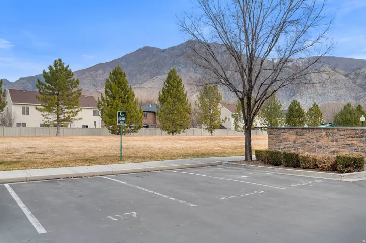 Uncovered parking lot featuring a mountain view