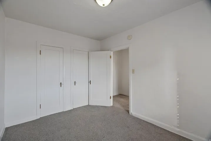 Unfurnished bedroom with carpet floors and a closet