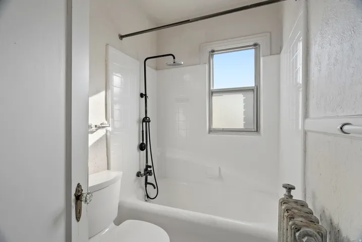 Full bathroom with  shower combination and toilet