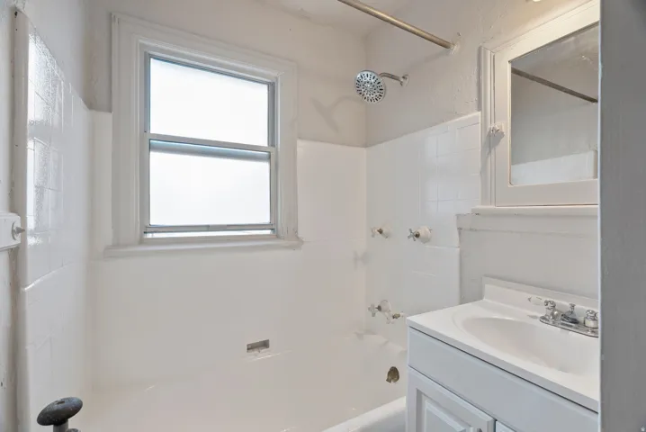 Bathroom with vanity and shower / tub combination