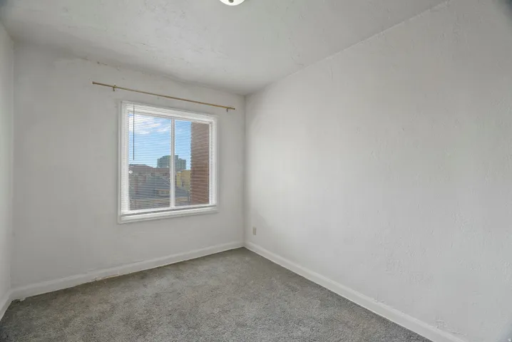 Spare room with carpet flooring and a textured wall