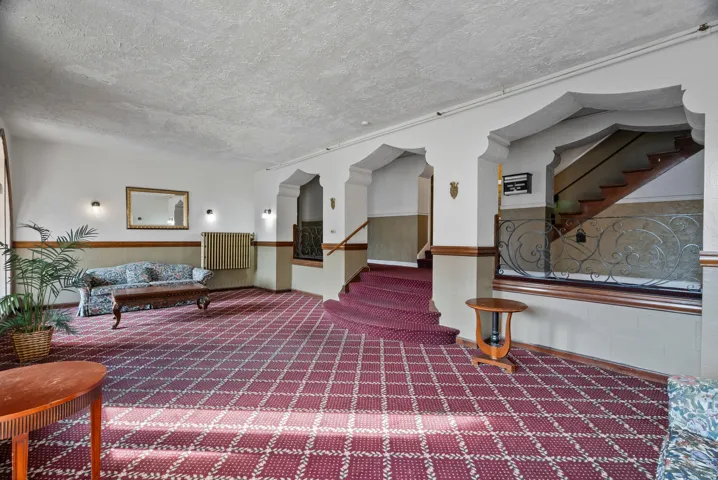 Lobby with stairway and a textured ceiling