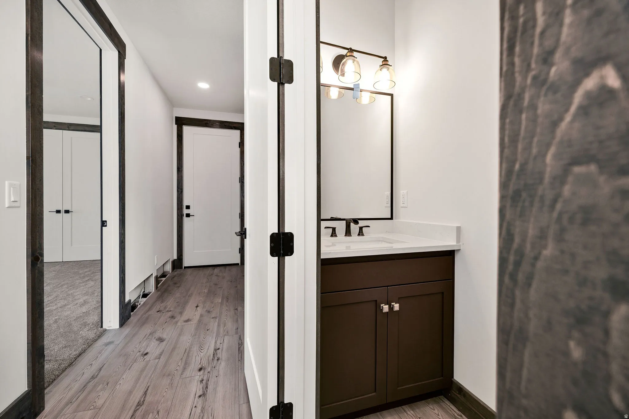 Bathroom with vanity, light wood-style floors, and recessed lighting