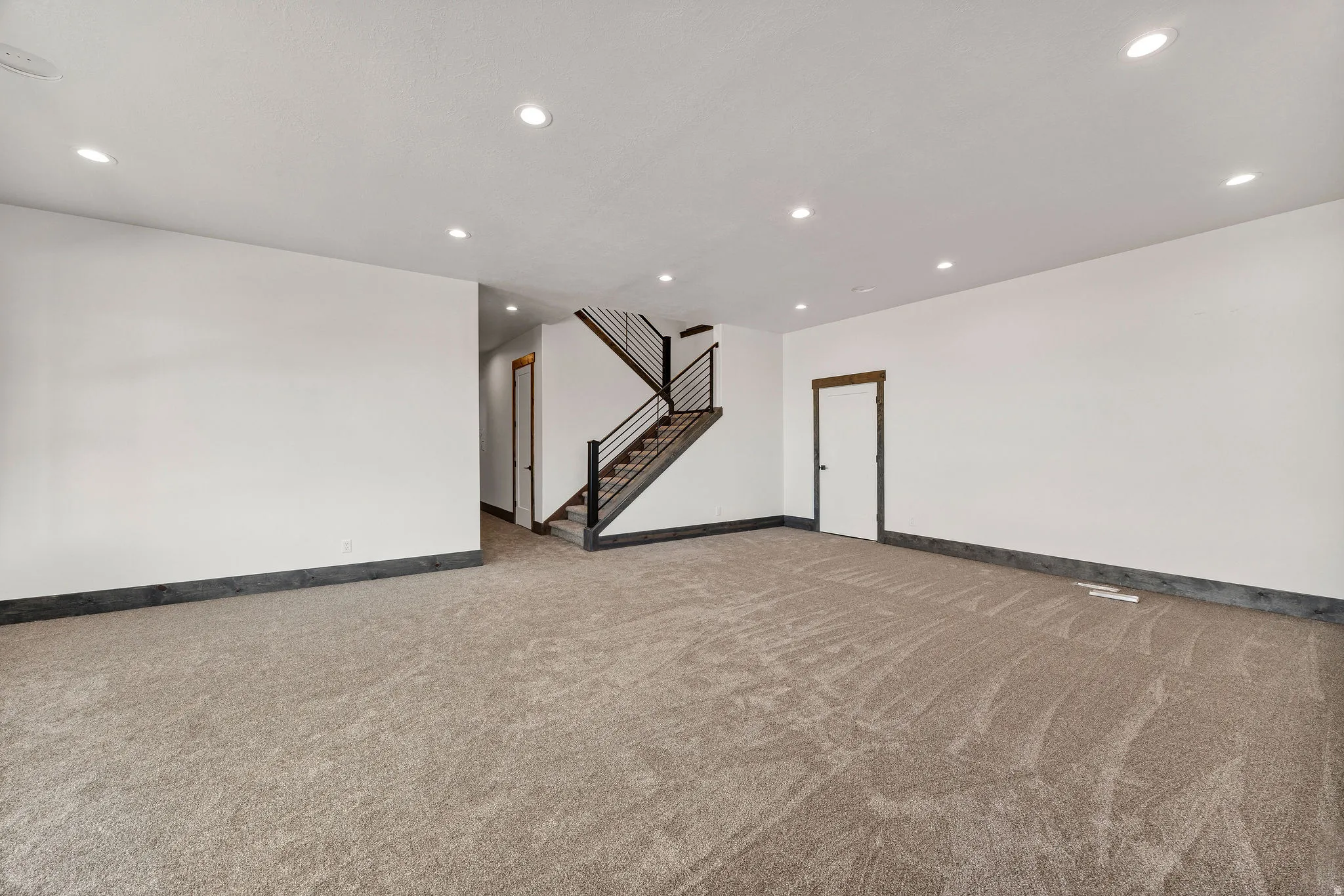Below grade area with recessed lighting and light carpet