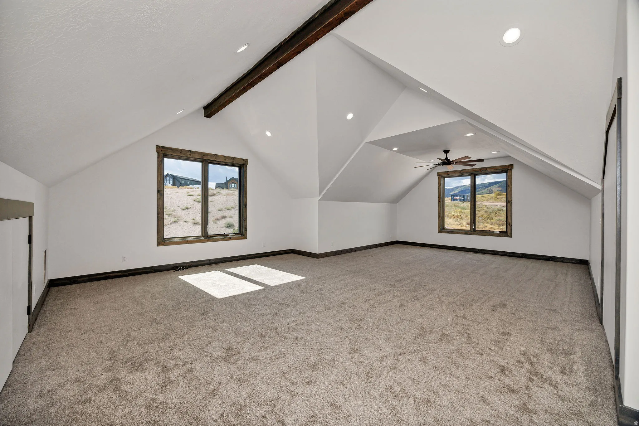 Bonus room featuring light colored carpet, beam ceiling, and recessed lighting