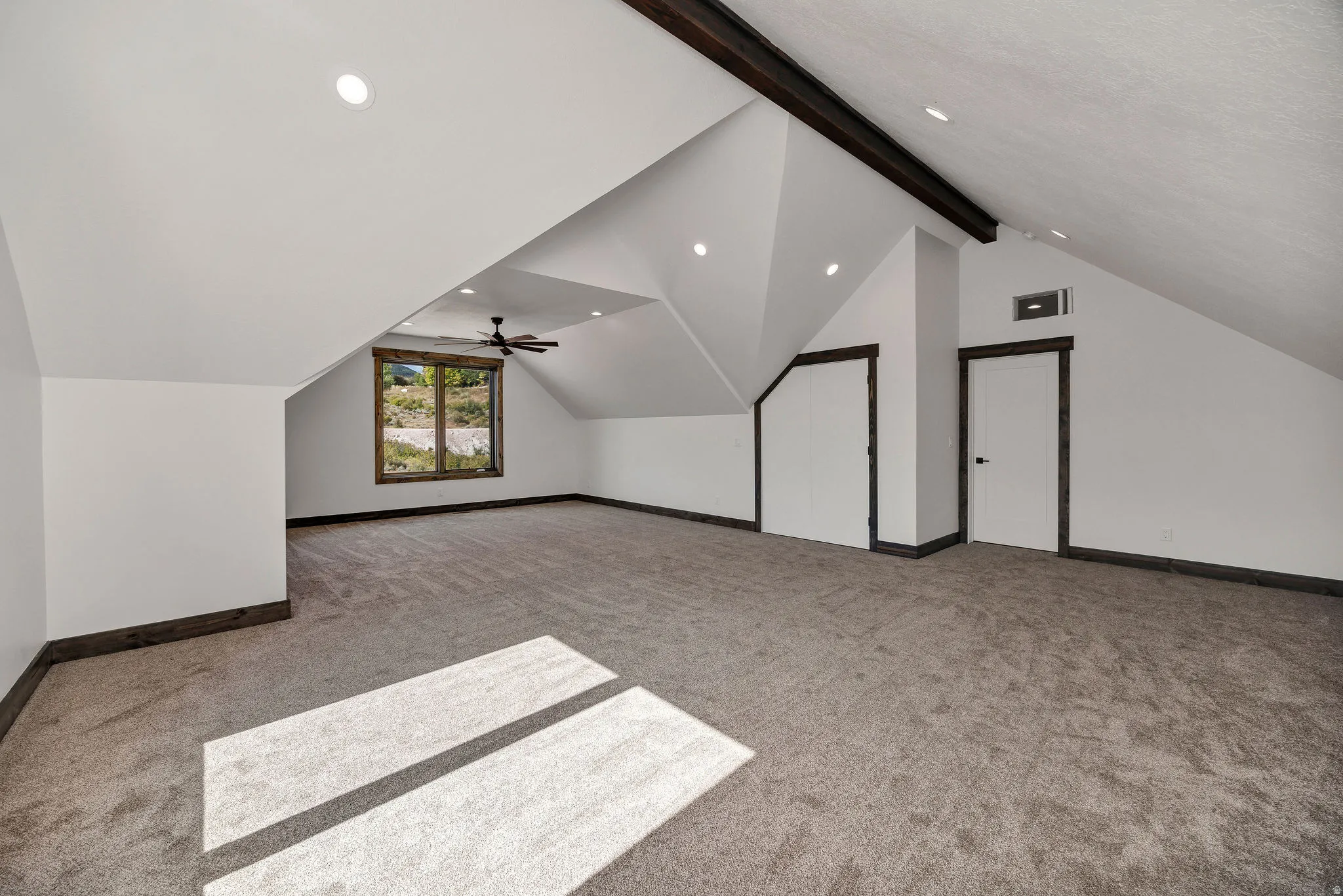 Bonus room with light colored carpet, beamed ceiling, recessed lighting, and ceiling fan