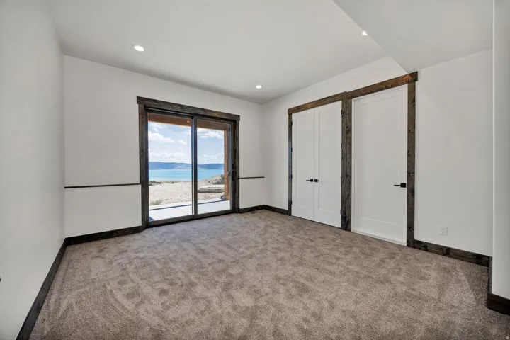 Unfurnished bedroom with carpet floors, access to outside, and recessed lighting
