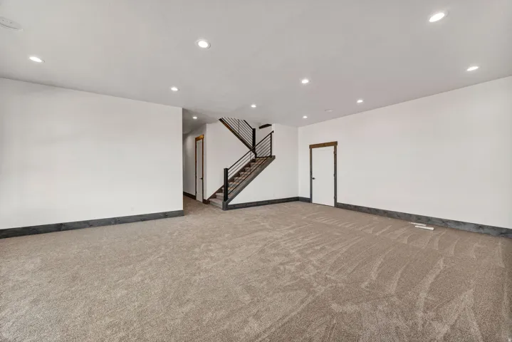 Below grade area with recessed lighting and light carpet