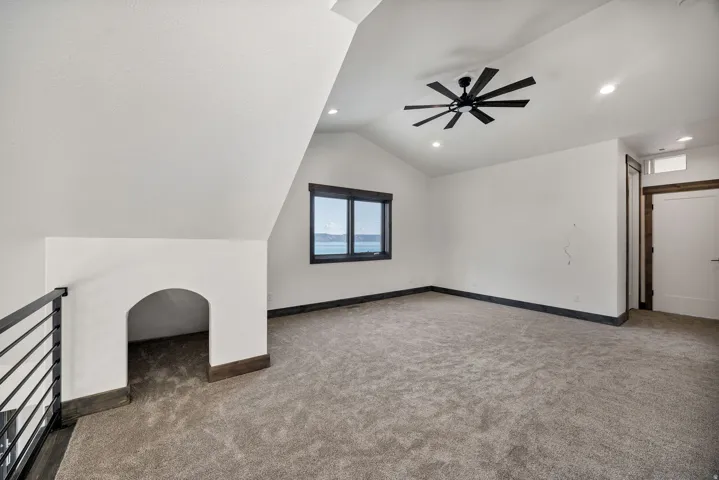 Additional living space with carpet, a ceiling fan, lofted ceiling, and recessed lighting