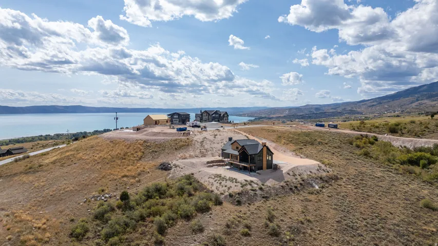 Aerial view of property and surrounding area featuring a water and mountain view