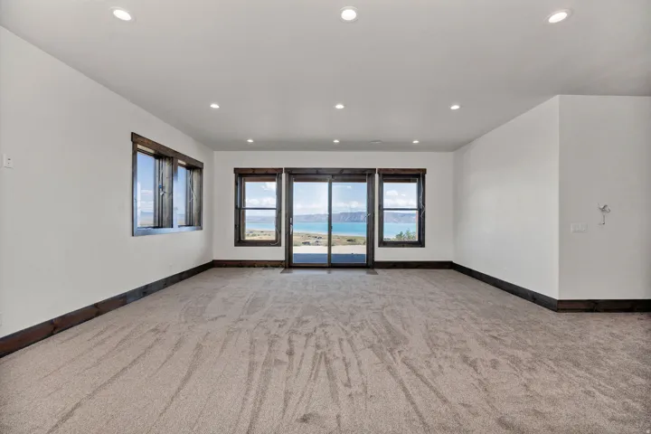 Empty room featuring light carpet and recessed lighting